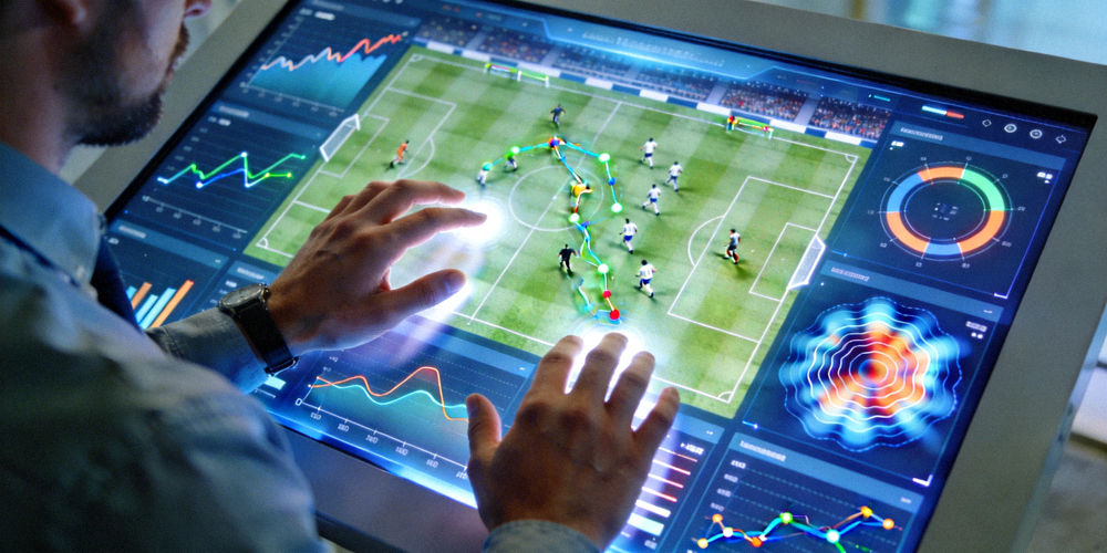 数据分析师正在操作触摸屏，屏幕上显示复杂的足球比赛数据可视化图表